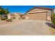 Exterior Elevation with a two-car garage and long driveway at 1994 E Dust Devil Dr, San Tan Valley, AZ 85143