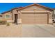 Close up of an Exterior Elevation with a two-car garage and tan stucco at 1994 E Dust Devil Dr, San Tan Valley, AZ 85143