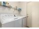 Practical laundry room with washer, dryer, and convenient shelving at 1994 E Dust Devil Dr, San Tan Valley, AZ 85143