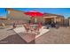 Inviting patio setup with dining area and desert landscaping at 1994 E Dust Devil Dr, San Tan Valley, AZ 85143