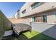 The backyard features low-maintenance turf and patio at 25318 N 19Th Dr, Phoenix, AZ 85085
