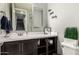 Cozy powder room with a modern vanity, mirror, and decorative wall art, exuding a clean aesthetic at 25318 N 19Th Dr, Phoenix, AZ 85085