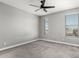 Clean bedroom with neutral colors, carpeted floor, and natural light from two different windows at 25318 N 19Th Dr, Phoenix, AZ 85085
