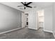 Spacious bedroom with carpeted floor, ceiling fan, and two doors - one to the bathroom and one to the closet at 25318 N 19Th Dr, Phoenix, AZ 85085