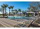 Relaxing community pool with a splash pad, seating, and lush palm trees at 25318 N 19Th Dr, Phoenix, AZ 85085