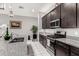 Well-equipped kitchen featuring stainless steel appliances, granite countertops, and dark cabinets at 25318 N 19Th Dr, Phoenix, AZ 85085
