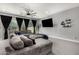 Cozy living room with a large gray sectional sofa, dark curtains, and modern decor at 25318 N 19Th Dr, Phoenix, AZ 85085