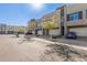 Street view of modern townhomes featuring multiple garages and desert landscaping at 25318 N 19Th Dr, Phoenix, AZ 85085