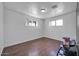 This unfurnished room features two windows, wood-look floors, and neutral walls at 2940 W Townley Ave, Phoenix, AZ 85051