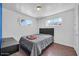 Bright bedroom with natural light streaming through dual windows, a comforting grey comforter at 2940 W Townley Ave, Phoenix, AZ 85051