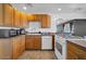 Well-lit kitchen features wood cabinets, tile floors, and modern appliances at 2940 W Townley Ave, Phoenix, AZ 85051
