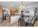 A spacious kitchen features wood cabinets, a breakfast bar and a connecting dining area at 2940 W Townley Ave, Phoenix, AZ 85051