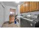 This laundry room includes modern appliances, natural light, and cabinetry at 2940 W Townley Ave, Phoenix, AZ 85051
