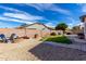 The backyard has a block wall, trees, patio, and a rock water feature near the pool at 3426 E Elgin St, Gilbert, AZ 85295