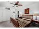 Bedroom with ceiling fan, wood bed frame, side tables with lamps, and closet doors at 3426 E Elgin St, Gilbert, AZ 85295