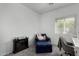 Neutral bedroom with a comfortable chair, an electric fireplace, and a cozy atmosphere at 3426 E Elgin St, Gilbert, AZ 85295