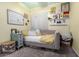 Bright bedroom with daybed and shelves, decorated with personal touches and natural light at 3426 E Elgin St, Gilbert, AZ 85295