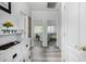 Bright hallway featuring wood floors, white trim, and views into adjacent rooms at 3426 E Elgin St, Gilbert, AZ 85295