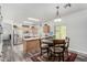 Open-concept kitchen and dining area with stainless steel appliances and a cozy dining set at 3426 E Elgin St, Gilbert, AZ 85295