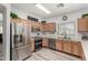 Well-lit kitchen boasts stainless steel appliances, wooden cabinets, and modern flooring at 3426 E Elgin St, Gilbert, AZ 85295