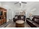 Spacious living room with leather sofas, open layout, and access to the kitchen and dining area at 3426 E Elgin St, Gilbert, AZ 85295