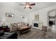 Bright living room with a ceiling fan, decorative fireplace, and stylish decor at 3426 E Elgin St, Gilbert, AZ 85295