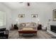 Bright living room with a ceiling fan, decorative fireplace, and stylish decor at 3426 E Elgin St, Gilbert, AZ 85295