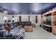 Large living room with plush sofa, rustic coffee table, and ample natural light at 3426 E Elgin St, Gilbert, AZ 85295