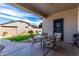Covered patio with a glass-topped table and chairs, overlooking a well-maintained yard at 3426 E Elgin St, Gilbert, AZ 85295