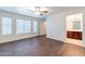Bright bedroom features wood-look floors, ceiling fan, and doorway to bathroom at 35005 N 30Th Dr, Phoenix, AZ 85086