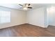 A bedroom with a ceiling fan, wood floors, and a window at 35005 N 30Th Dr, Phoenix, AZ 85086