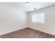 Bedroom with wood floors, a window, and neutral paint at 35005 N 30Th Dr, Phoenix, AZ 85086