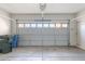 Spacious garage with overhead lighting, a windowed door, and plenty of room for parking and storage at 35005 N 30Th Dr, Phoenix, AZ 85086