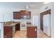 Well-equipped kitchen features stainless steel appliances, and dark wood cabinetry at 35005 N 30Th Dr, Phoenix, AZ 85086