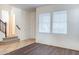 Comfortable living room featuring hardwood flooring and large windows for natural light at 35005 N 30Th Dr, Phoenix, AZ 85086