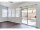Bright living room with hardwood floors and a sliding glass door that leads to the backyard at 35005 N 30Th Dr, Phoenix, AZ 85086