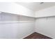 Empty walk-in closet with rod for hanging clothes and wood-look flooring at 35005 N 30Th Dr, Phoenix, AZ 85086