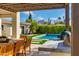 Inviting backyard pool area featuring a built-in grill, manicured lawn, and relaxing covered patio at 3727 E Highland Ave, Phoenix, AZ 85018