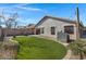 Backyard featuring artificial turf, a cozy seating area, and charming string lights at 4091 S Dew Drop Ct, Gilbert, AZ 85297