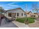 Backyard featuring artificial turf, a cozy seating area, and charming string lights at 4091 S Dew Drop Ct, Gilbert, AZ 85297