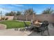 Backyard featuring artificial turf, a cozy seating area, and charming string lights at 4091 S Dew Drop Ct, Gilbert, AZ 85297