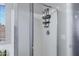 Clean shower stall featuring a shower head with shelving and sliding glass door at 4091 S Dew Drop Ct, Gilbert, AZ 85297