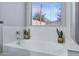 Bright bathroom featuring a soaking tub with plants and a window view at 4091 S Dew Drop Ct, Gilbert, AZ 85297