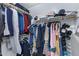 Walk-in closet with organized storage and a variety of clothing at 4091 S Dew Drop Ct, Gilbert, AZ 85297