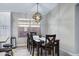 Cozy dining area with a modern light fixture, wood-look floors, and a view of the backyard at 4091 S Dew Drop Ct, Gilbert, AZ 85297