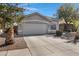 Inviting home with a spacious driveway, desert landscaping, and an attached two-car garage at 4091 S Dew Drop Ct, Gilbert, AZ 85297