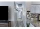 Bright hallway with tile flooring, neutral walls, and granite counters at 4091 S Dew Drop Ct, Gilbert, AZ 85297
