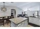 Bright kitchen featuring a large island, stainless steel appliances, and an open layout leading to the living room at 4091 S Dew Drop Ct, Gilbert, AZ 85297