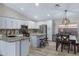 Modern kitchen with a large island, stainless steel appliances, granite countertops, and adjacent dining area at 4091 S Dew Drop Ct, Gilbert, AZ 85297
