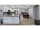 Well-equipped kitchen with white cabinets, granite countertops, and stainless steel appliances, seamlessly flowing into the dining area at 4091 S Dew Drop Ct, Gilbert, AZ 85297